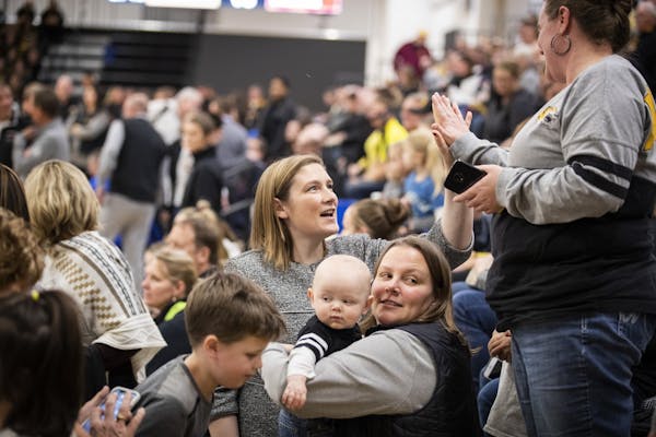 Lindsay Whalen greets people in the crowd after the ceremony.where the remodeled Hutchinson High School gym was named for her.