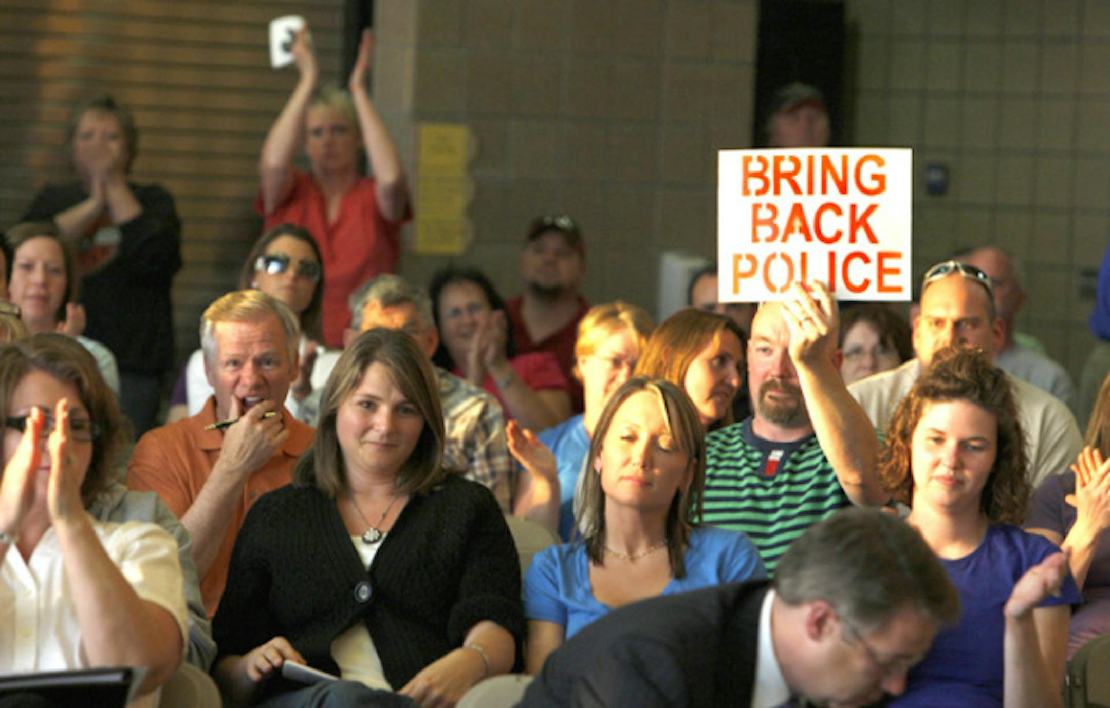 Some citizens applauded after attorney Bob Bauer, sitting at bottom right, addressed the Elko New Market City Council on Thursday night. Bauer said the council was violating its own ordinance by voting to eliminate the Police Department. The Apple Valley attorney said he was hired by a "concerned citizen" to review the council's actions.