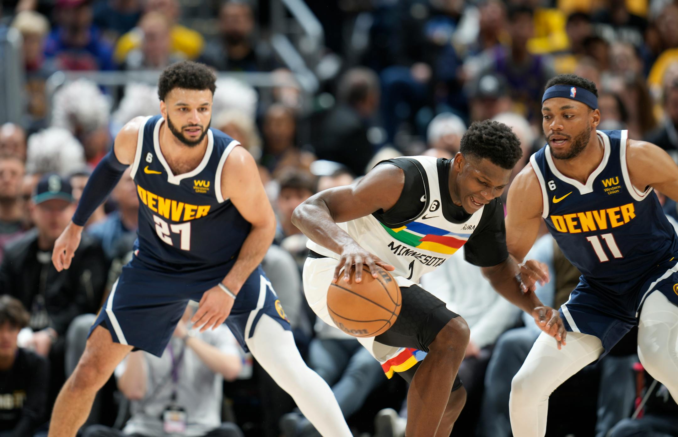 Minnesota Timberwolves guard Anthony Edwards, center, struggles to control the ball as Denver Nuggets guard Jamal Murray, left, and forward Bruce Brown defend during the second half of Game 2. Edwards led all scorers with 41 points.