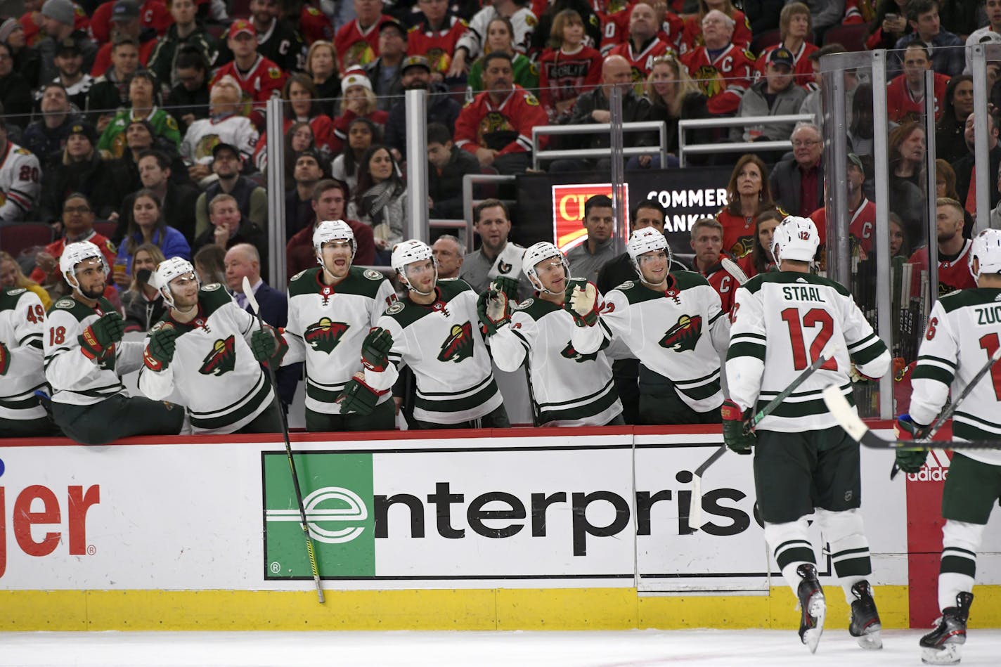 Minnesota Wild's Eric Staal (12) celebrates with teammates on the bench after scoring a goal during the first period of an NHL hockey game against the Chicago Blackhawks, Sunday, Dec. 15, 2019, in Chicago. (AP Photo/Paul Beaty)