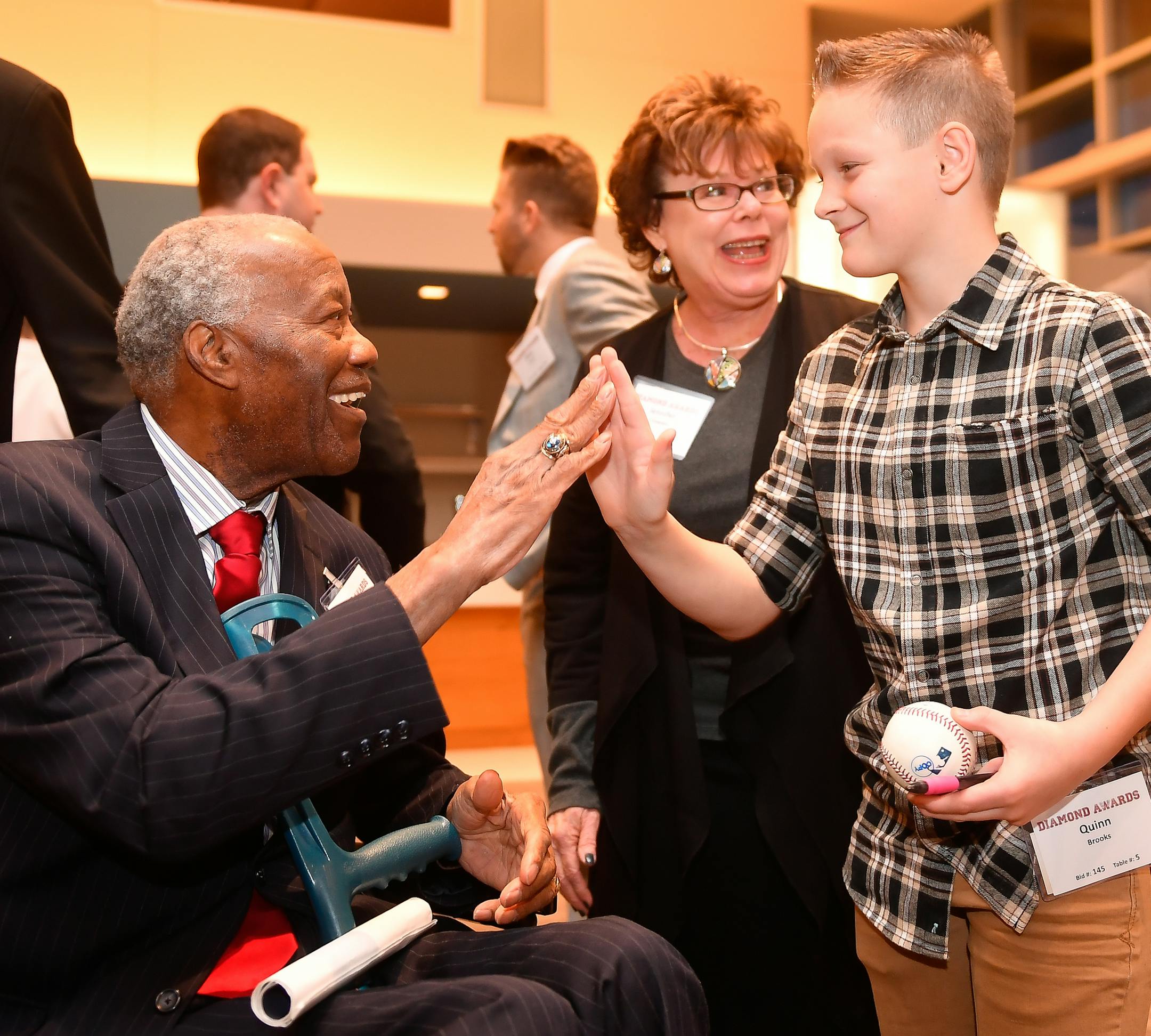Jim "Mudcat" Grant, a World Series winning pitcher for the 1965 Minnesota Twins, high fived Quinn Brooks, 11, of Sioux Falls, S.D., during a VIP event held before the 2017 Diamond Awards Thursday night. ] AARON LAVINSKY • aaron.lavinsky@startribune.com The Minnesota Twins held the 2017 Diamond Awards on Thursday, Jan. 26, 2017 at Target Field in Minneapolis, Minn.