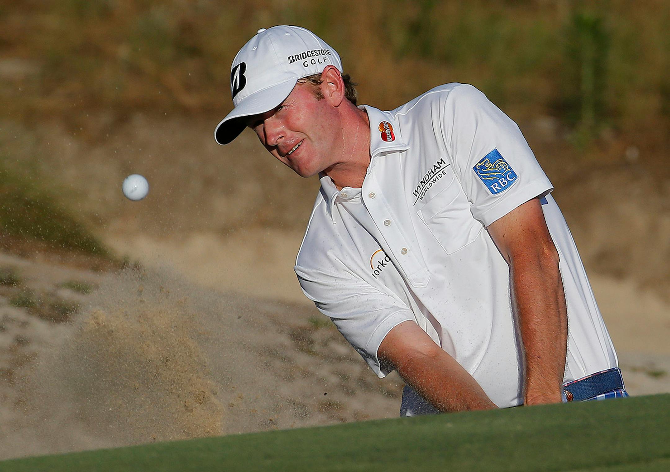 Brandt Snedeker hits out of the bunker on the 16th hole during the third round of the U.S. Open golf tournament in Pinehurst, N.C., Saturday, June 14, 2014.