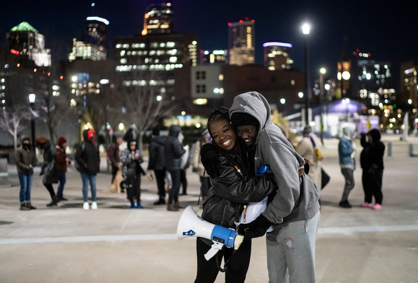 Nyagach Kueth, 17, and Markeanna Dionne, 17, hug as they lead a rally outside of U.S. Bank Stadium for the Prior Lake High School student who was victim in a racist bullying incident and against racism in schools and policing on Friday, Nov. 19, 2021, in Minneapolis, Minn. The rally of more than 40 people was led by and mostly attended by teens. ] RENEE JONES SCHNEIDER • renee.jones@startribune.com