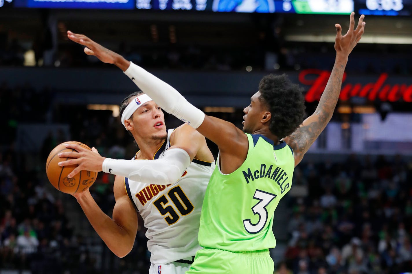 Denver Nuggets forward Aaron Gordon (50) looks to pass as Minnesota Timberwolves forward Jaden McDaniels (3) defends during the third quarter of an NBA basketball game Saturday, Oct. 30, 2021, in Minneapolis. The Nuggets won 93-91. (AP Photo/Bruce Kluckhohn)