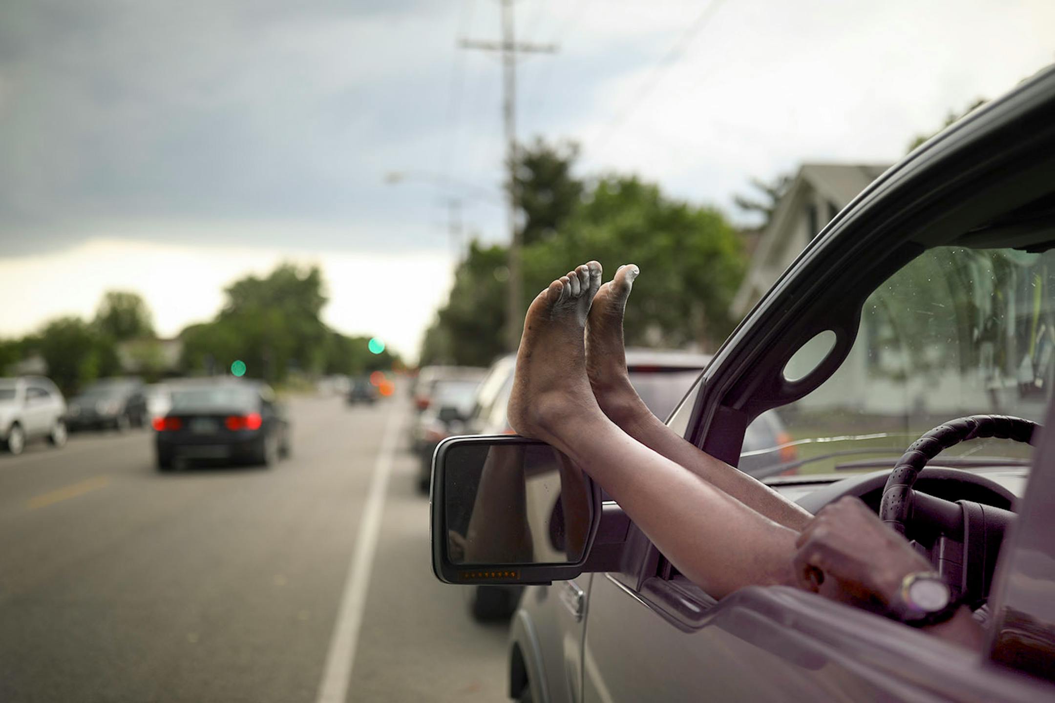 Charlie Ware rested his feet while sitting in his vehicle across from Lake Hiawatha Park on 28th Ave. S. in Minneapolis Monday afternoon.