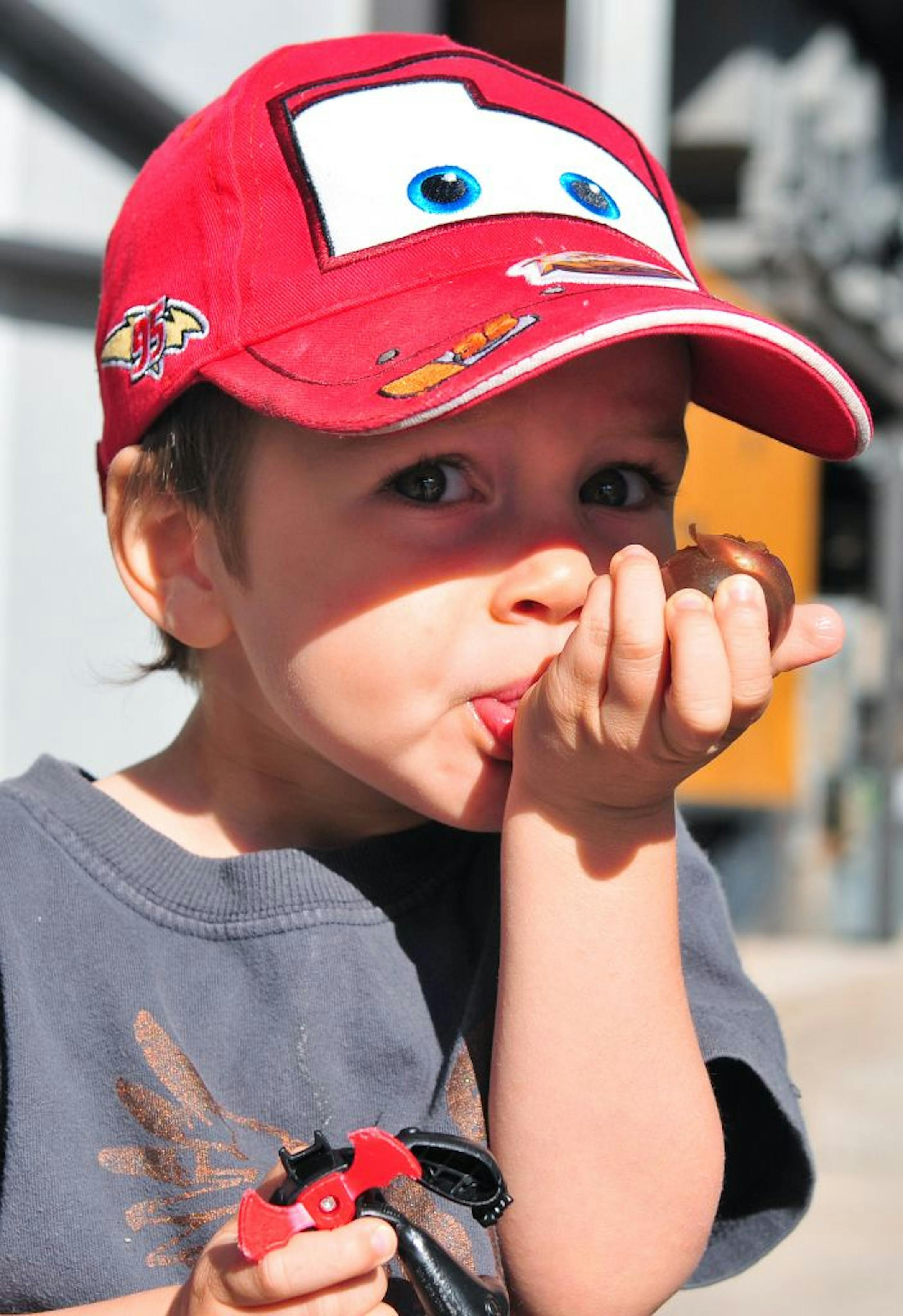 Mason Meindl, 2, tastes a cherry tomato Saturday, June 2 at the Mill City Farmers Market in Minneapolis. This was Mason first trip to the Mill City Farmers Market with his mother, Lindsey, dad, Emil and little brother, Wesley.