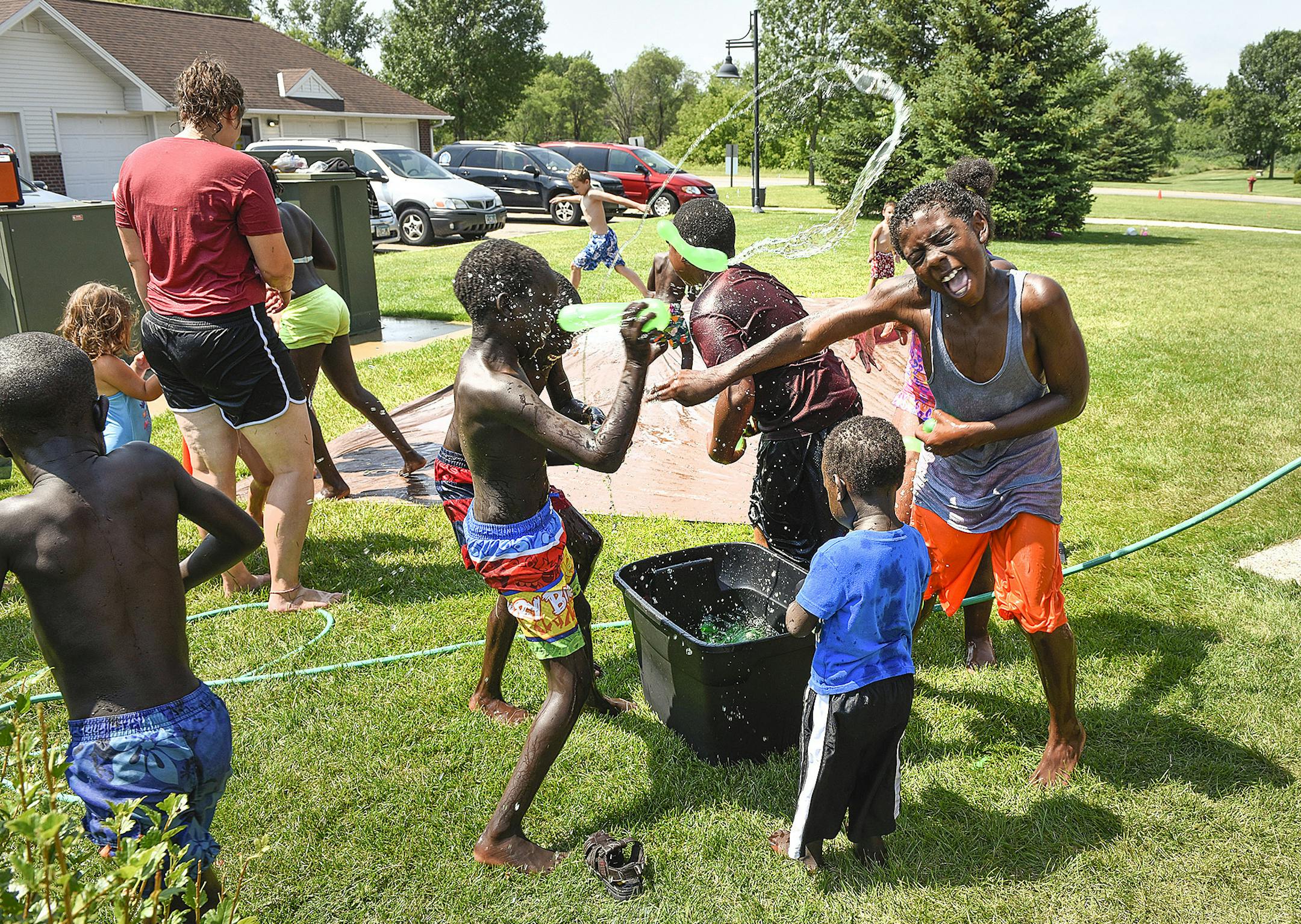 FOR RELEASE MONDAY, AUGUST 8, 2016, AT 12:01 A.M. CDT.-A water balloon fight was a highlight of the YES Network visit before lunch Wednesday, July 20, 2016, to the Westwood Village Apartments in St. Cloud, Minn. (St. Cloud Times/Jason Wachter via AP)