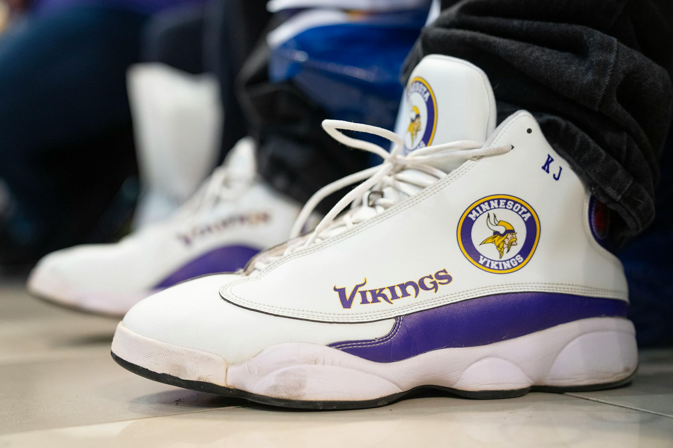 Kenny Juergens wears his custom Minnesota Vikings sneakers during a Vikings fan rally.