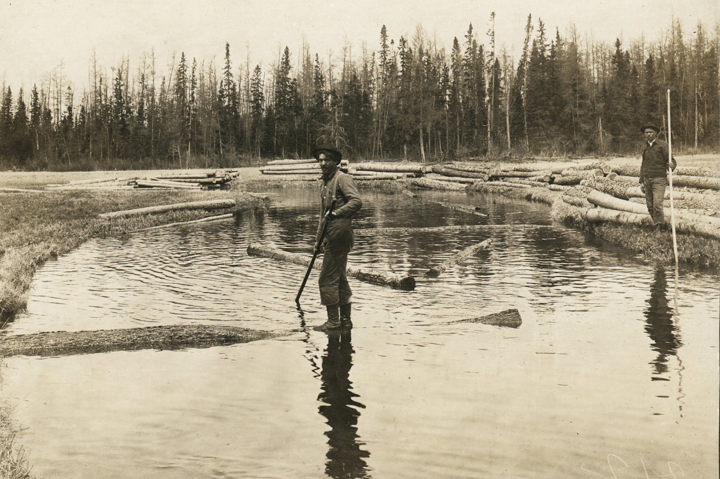 Two unidentified &#x201c;river-pigs,&#x201d; men who poled the logs downstream, on the Mississippi River.