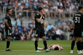 Minnesota United defender Miguel Tapias, center, reacts after being issued a yellow card during the first half of an MLS soccer match against the Port