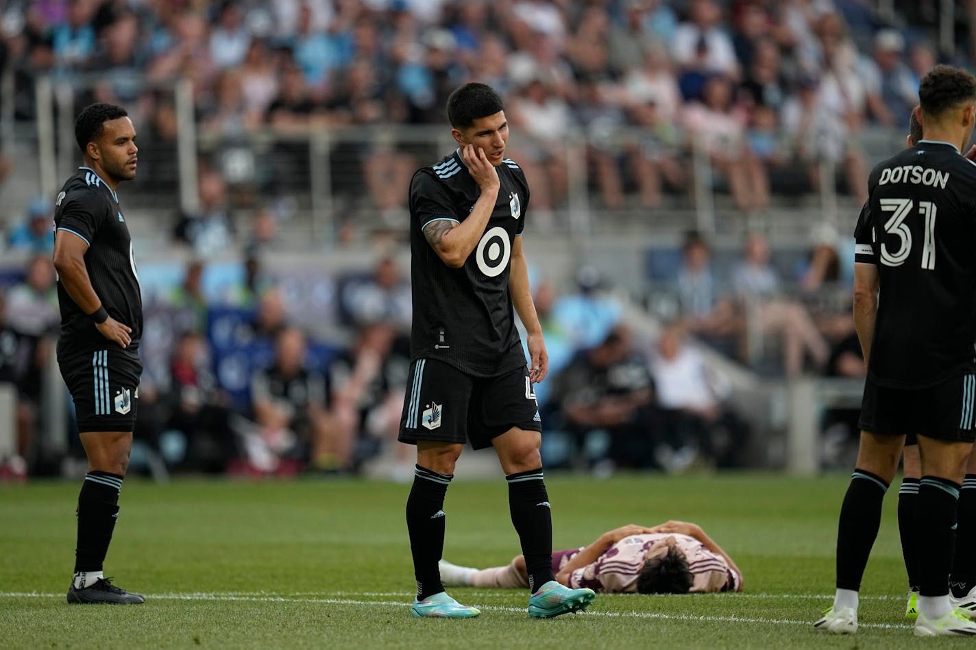 Minnesota United defender Miguel Tapias, center, reacts after being issued a yellow card during the first half of an MLS soccer match against the Portland Timbers, Saturday, July 1, 2023, in St. Paul, Minn. (AP Photo/Abbie Parr)