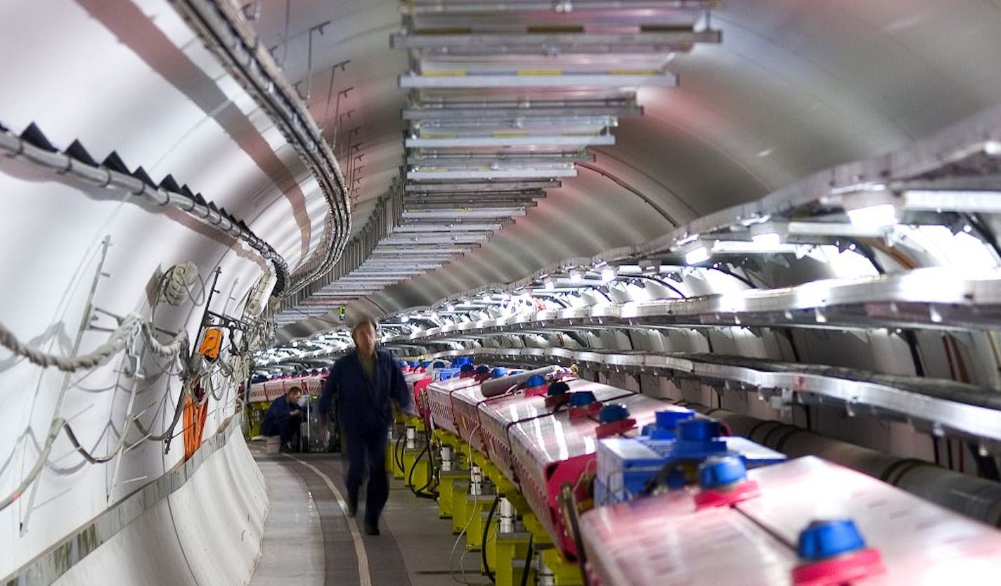 In this 2005 photo provided by CERN, the European Organization for Nuclear Research, technicians check the magnets that will direct protons towards the target for the CERN Neutrinos to Gran Sasso (CNGS) project in Geneva. The project team, a collaboration between France's National Institute for Nuclear and Particle Physics Research and Italy's Gran Sasso National Laboratory, fired a neutrino beam 454 miles (730 kilometers) underground from Geneva to Italy. They found it traveled 60 nanoseconds f