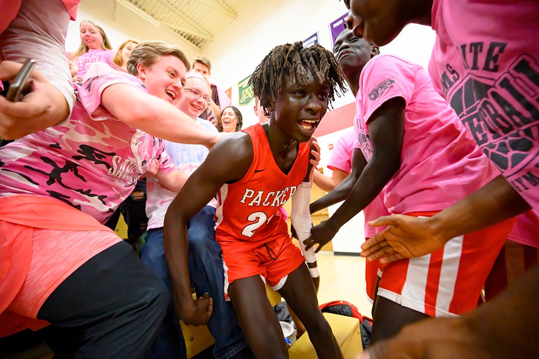Agwa Nywesh celebrated in the Austin student section after making a last-second basket to win Monday night's game against Rochester Mayo on Jan. 27.