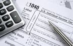 iStockphoto.com A 1040 Individual tax form with calculator and pencil.