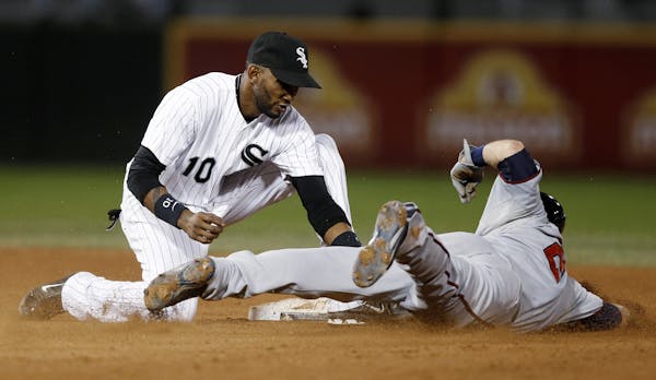 Chicago White Sox shortstop Alexei Ramirez tags out Minnesota Twins' Brian Dozier on an attempted stolen base during the fifth inning of a baseball ga