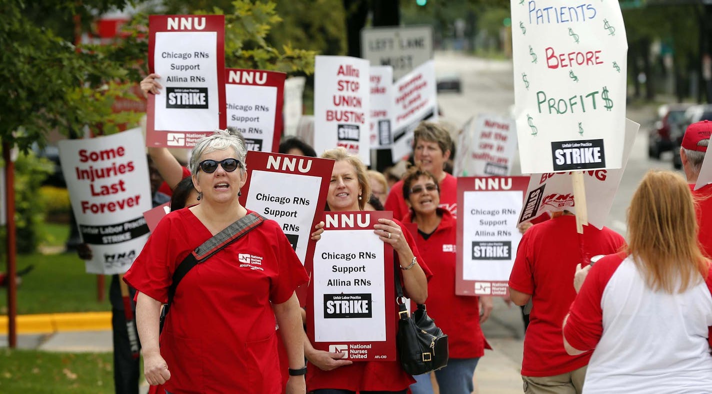 Allina Health nurses protest outside Abbott Northwestern Hospital in Minneapolis on Monday, Sept. 5, 2016 as they began an open-ended strike after a failure to reach a settlement with Allina Health. Nurses are walking picket lines at five Minnesota hospitals in a strike over health insurance, workplace safety and staffing. (AP Photo/Jim Mone) ORG XMIT: MIN2016090914081612 ORG XMIT: MIN1609131149261151