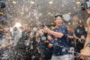 Minnesota Twins starting pitcher Kenta Maeda (18) and other Twins players celebrate with champagne in the locker room after clentched the American Lea