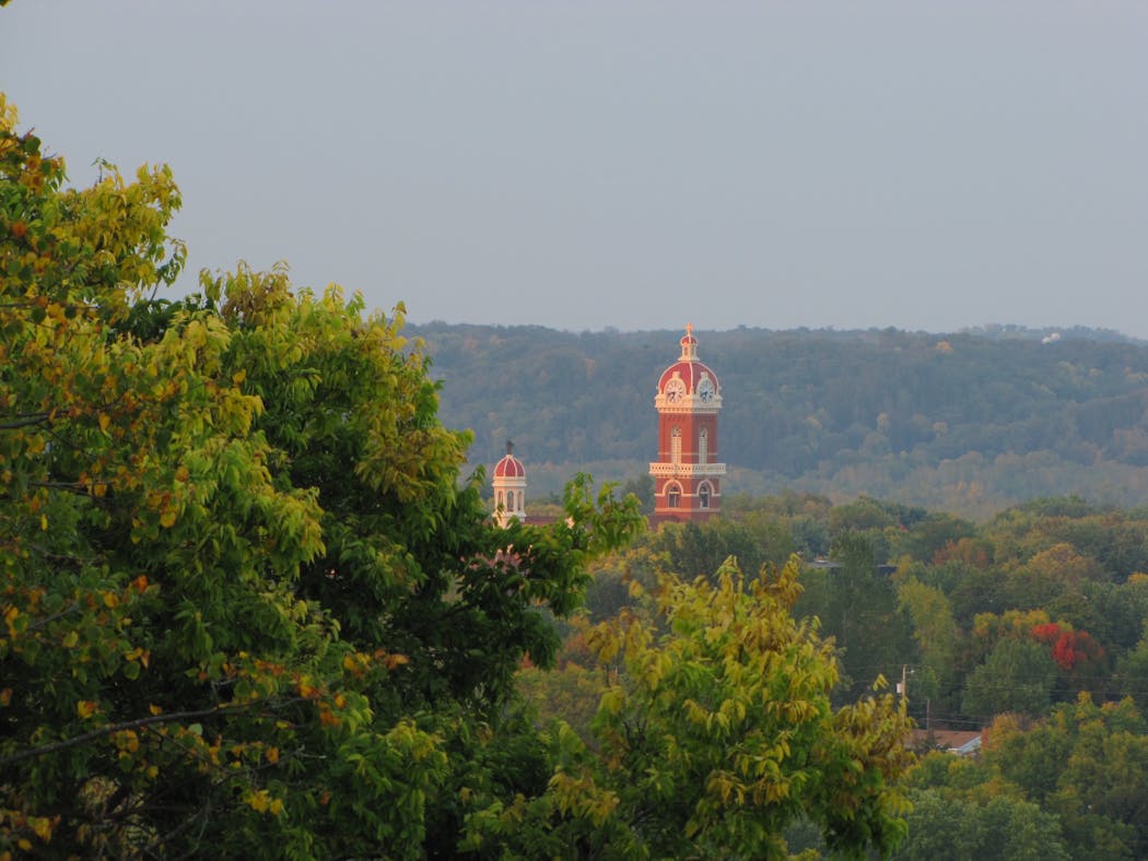New Ulm’s Cathedral of the Holy Trinity emerges from the treetops in the Minnesota River Valley town.