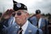 At the State Veterans Cemetery in LIttle Falls, Korean Veteran and Marines Ervin Lewandowski of Coon Rapids saluted during the National Anthem and the