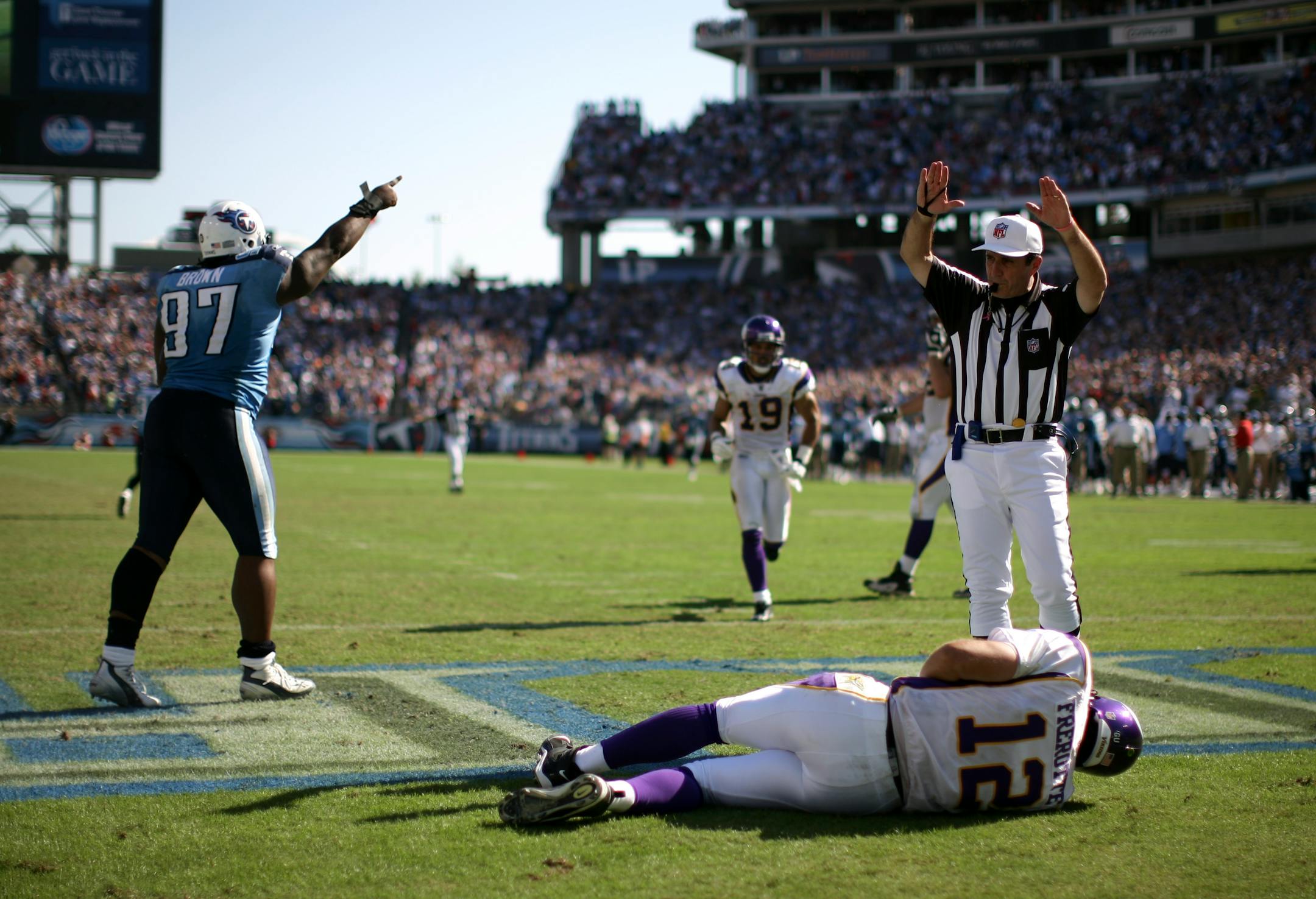 Vikings quarterback Gus Frerotte left the game after a late fourth quarter hit in the endzone by the Titan's Tony Brown, left.
