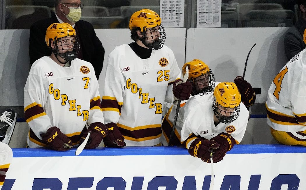 Gophers forward Brannon McManus, forward Jack Perbix and forward Scott Reedy looked on from the bench late in the third period of Minnesota State Mankato's 4-0 victory for the NCAA West Regional title Sunday.