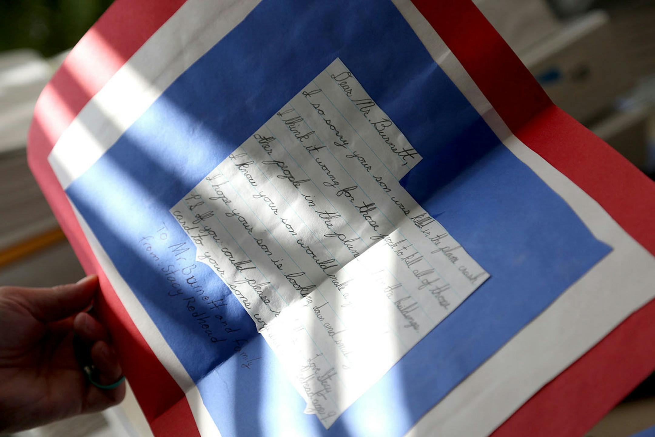 Mary Margaret Jurgens looked at one of the many cards that children had sent from around the country to th Burnett family in memory of her brother Tom Burnett Jr.