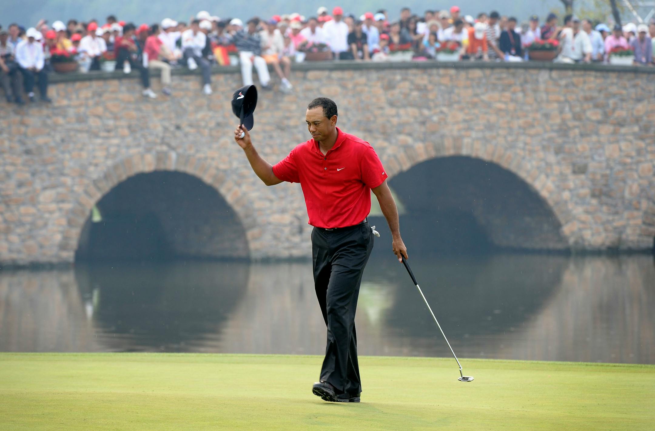 FILE - In this Sunday, Nov. 8, 2009 file photo, Tiger Woods of the United States acknowledges the spectators after he finished the 9th hole during the HSBC Champions golf tournament at the Sheshan International Golf Club in Shanghai, China.