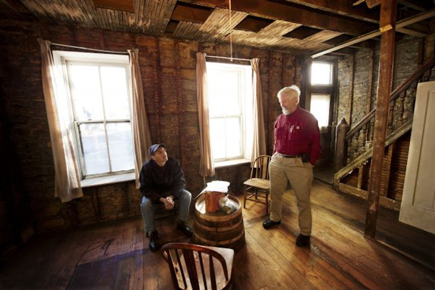 Attorney Tom Schroeder, left, and architect John Yust are gutting and renovating what they believe is St. Paul's oldest commercial building. Although it was used as a house for decades, the two St. Paul men hope to return it to its original use — as a 19th-century-style social club — and have the structure named to the National Register of Historic Places.