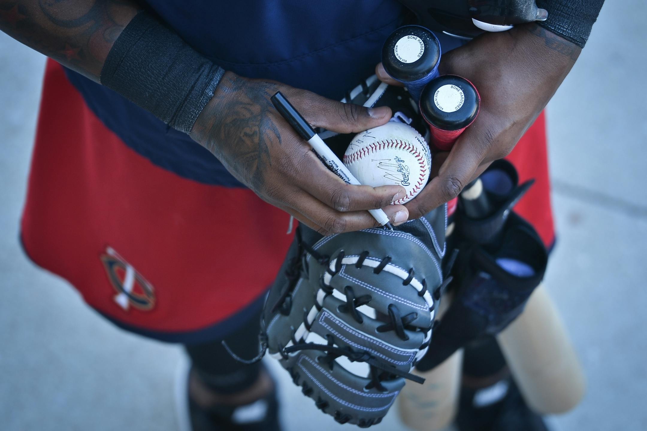 Minnesota Twins first baseman Kennys Vargas (19) signed a baseball for a young fan Friday.