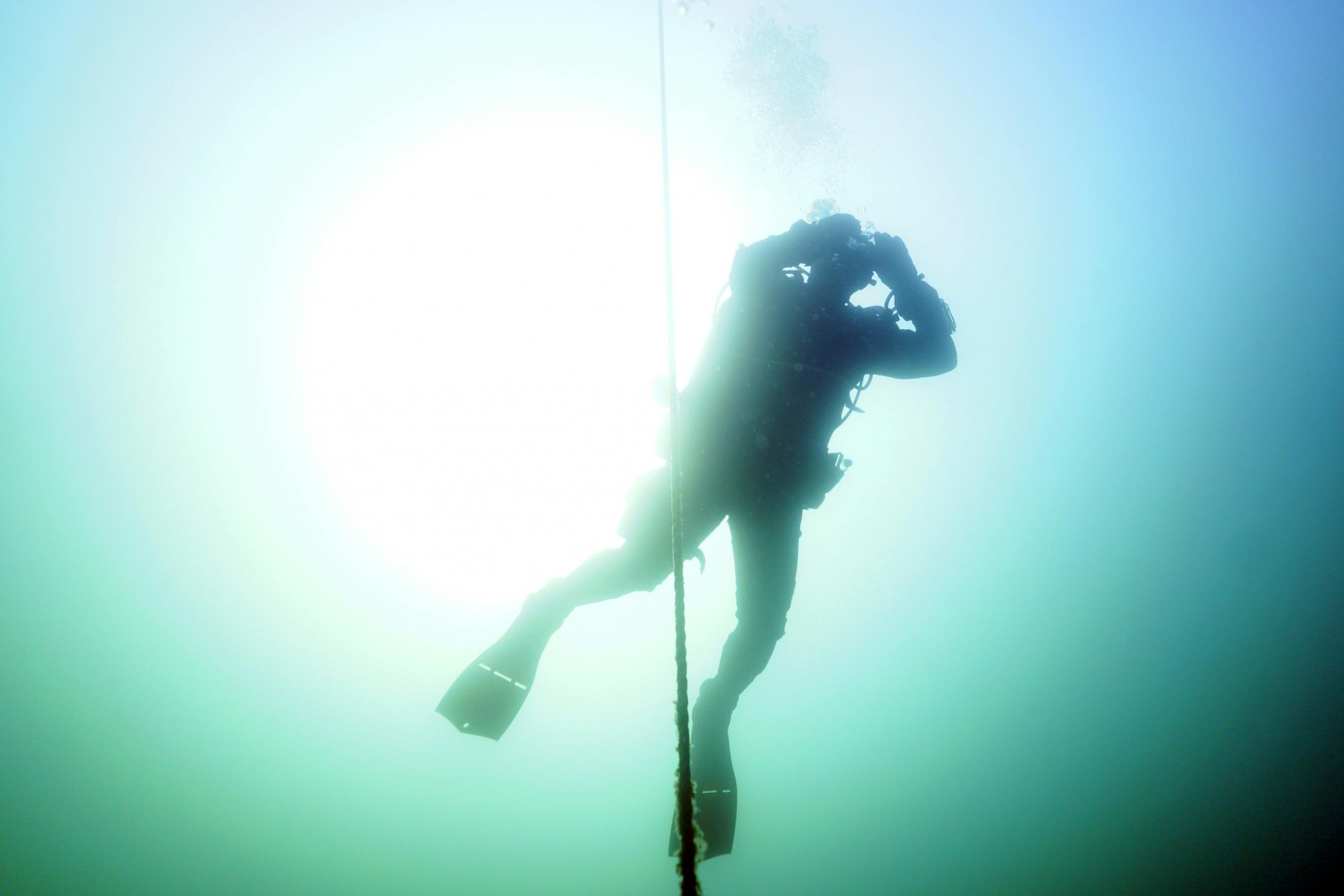 Jack Decker, a diver with the Great Lakes Shipwreck Preservation Society from Clear Lake, Iowa, cleared his mask as he followed the decent line down to the Hesper.