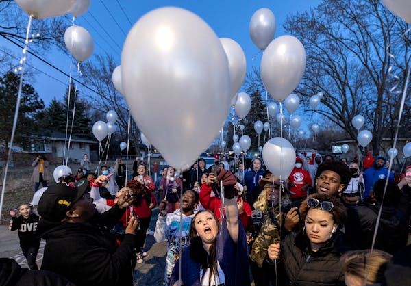 Katie Wright, mother of Daunte Wright, and attendees release balloons at a Vigil honoring Daunte Wright on one-year anniversary of his death Monday, A
