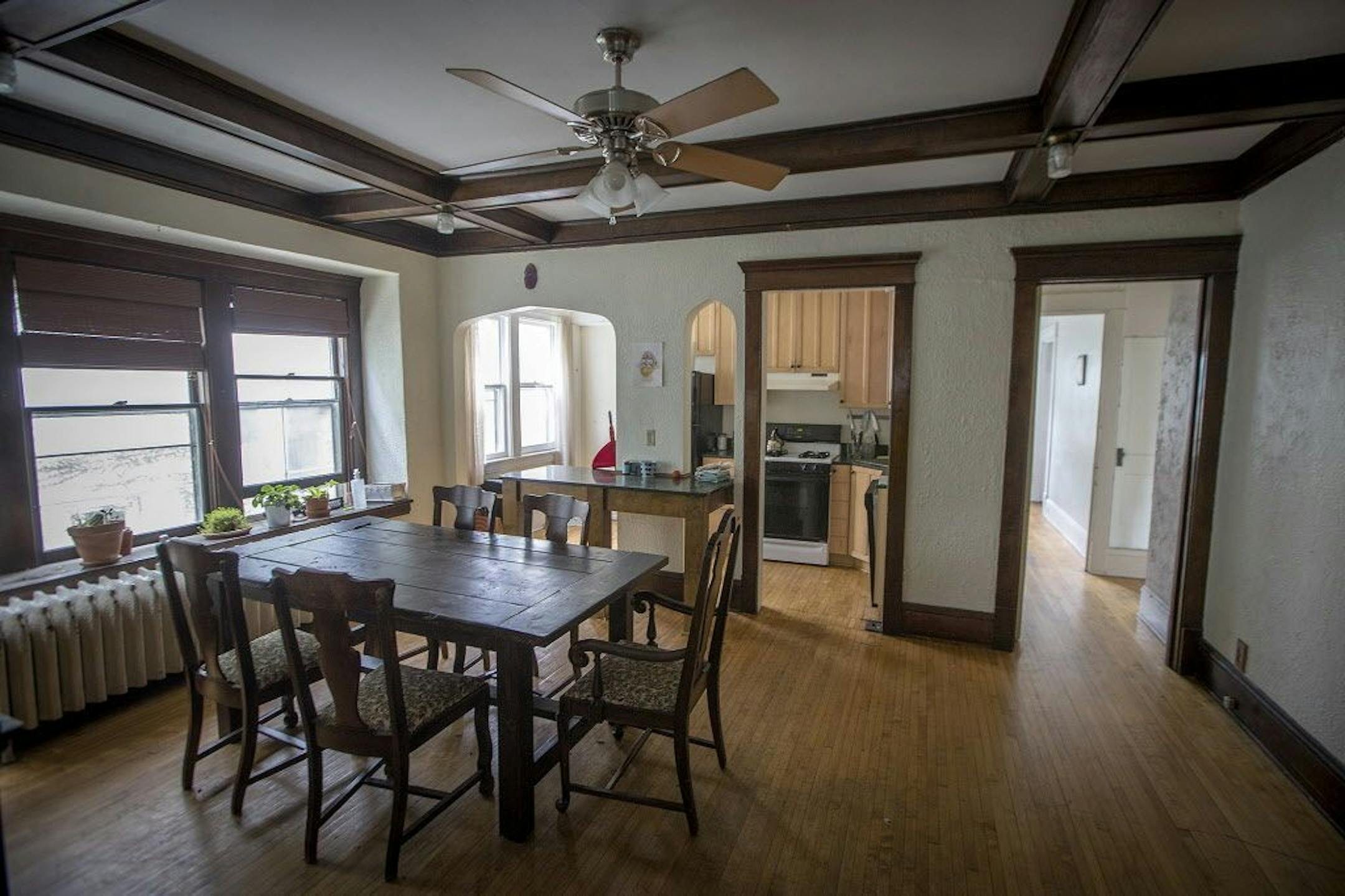 The dining room in a downstairs unit features a box-beam ceiling.