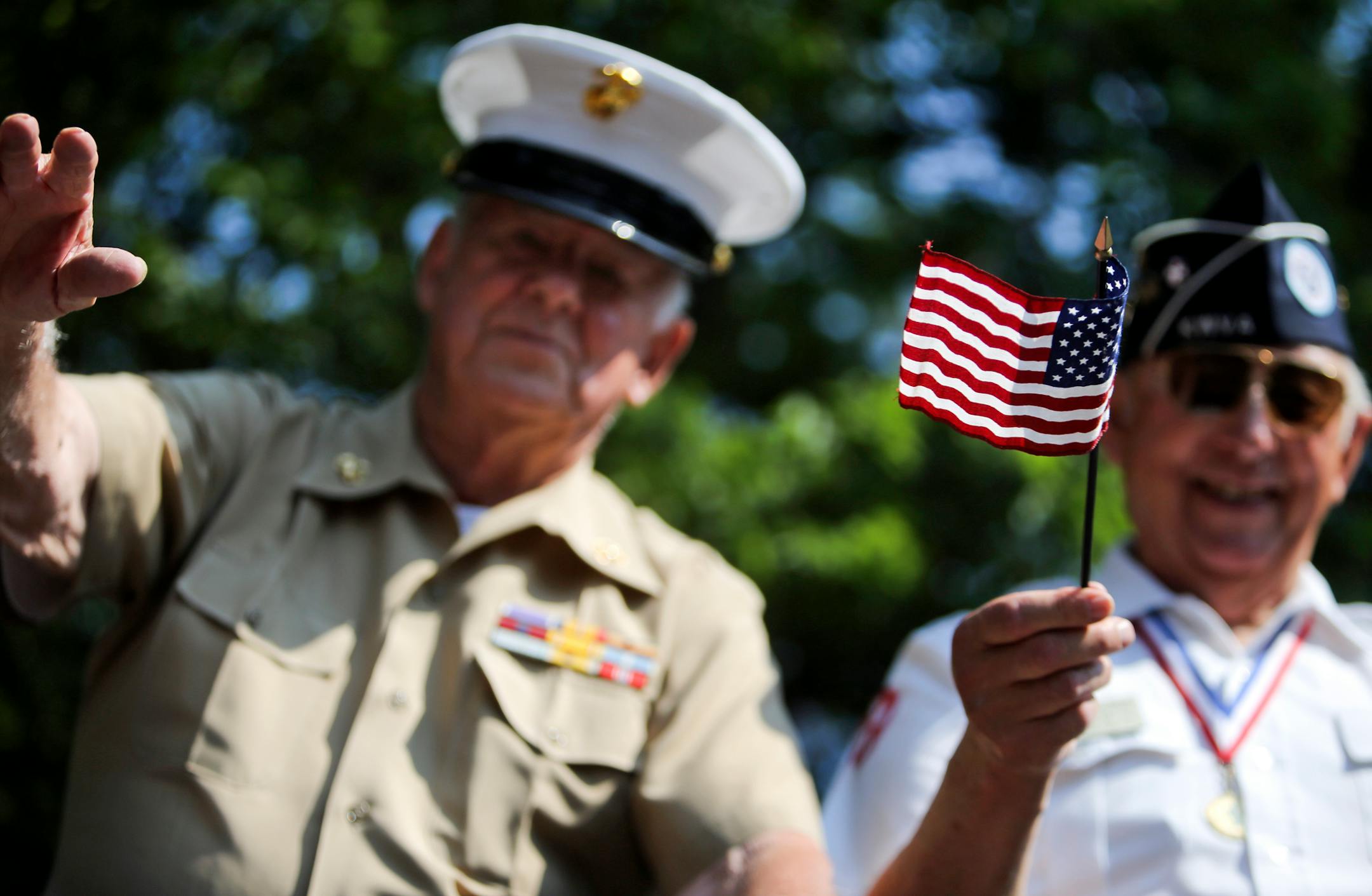 Passing Korean War vets in the back of a military truck waved while joining other U.S. veterans during Edina's July 4th parade in 2013.