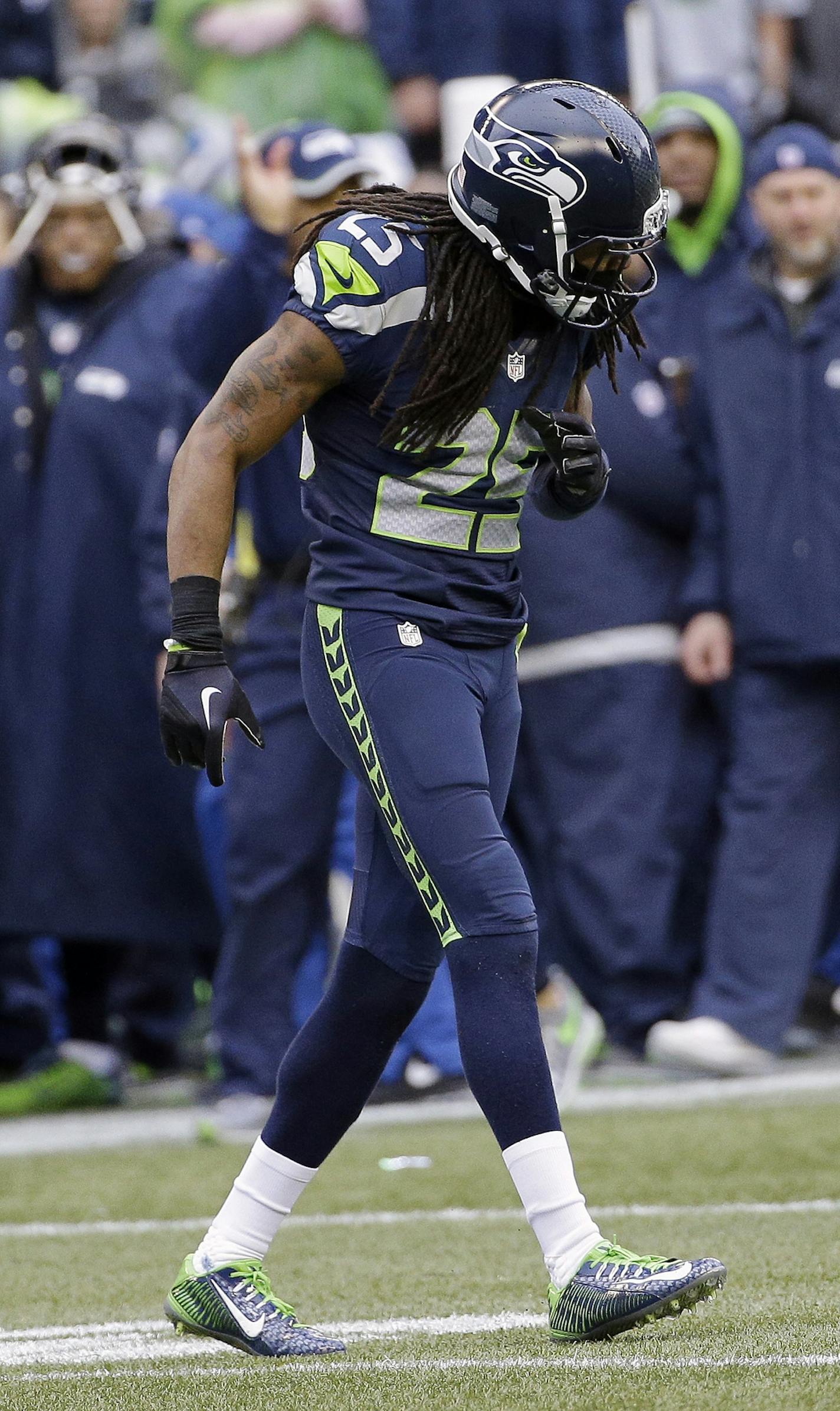 Seattle Seahawks' Richard Sherman appears hurt as he walks off the field during the second half of the NFL football NFC Championship game against the Green Bay Packers Sunday, Jan. 18, 2015, in Seattle. (AP Photo/David J. Phillip)