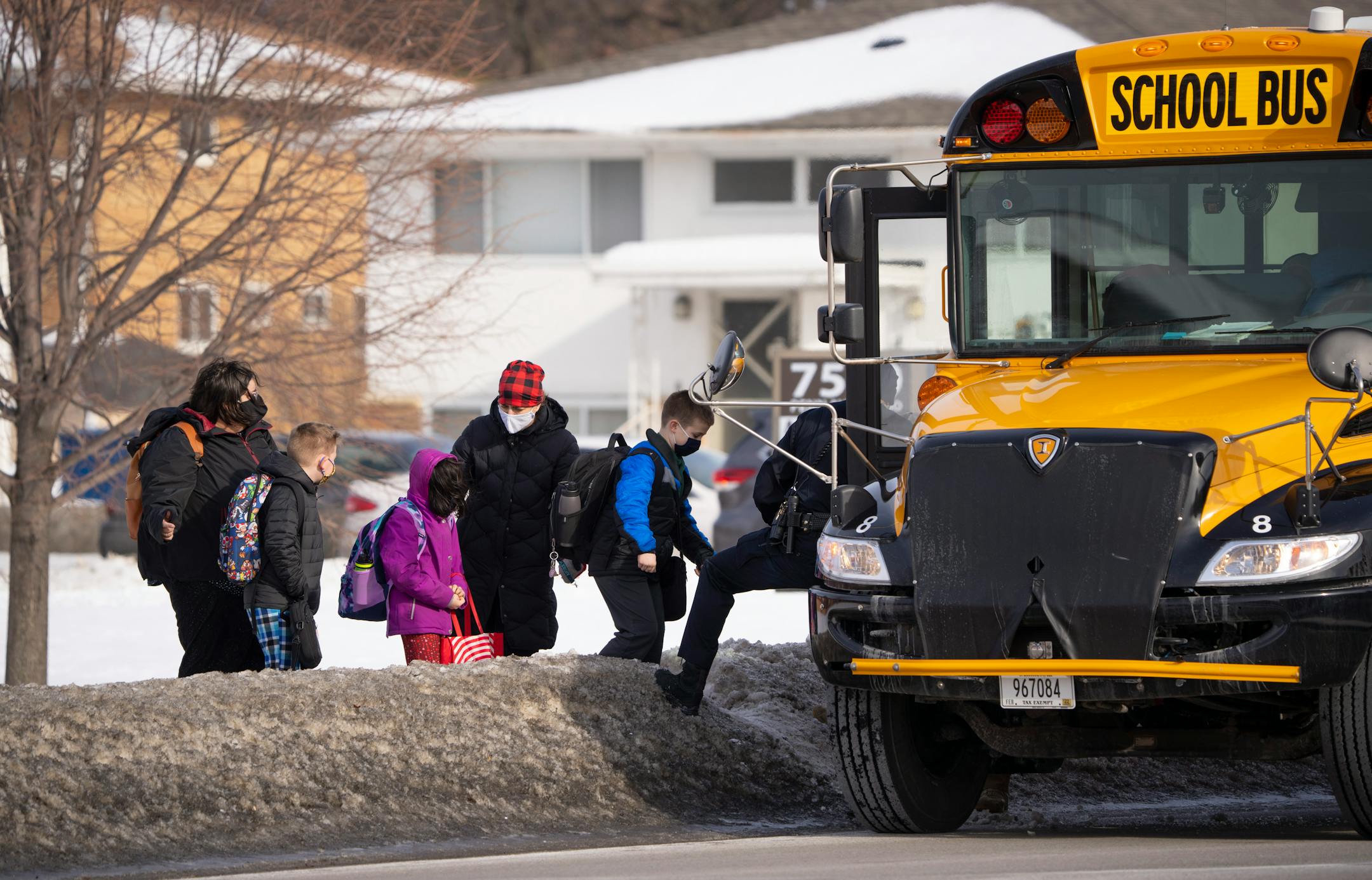 Students from Blessed Trinity Catholic School at St. Richard's Catholic Church were helped onto a waiting bus Tuesday afternoon, February 1, 2022. The school is across a parking lot from the South Education Center, an alternative school where two students were shot, one of them fatally Tuesday afternoon. ] JEFF WHEELER • Jeff.Wheeler@startribune.com