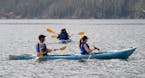 FILE - Kayakers ply the choppy waters of Grand Lake on Wednesday, Aug. 5, 2020, in Grand Lake, Colo.