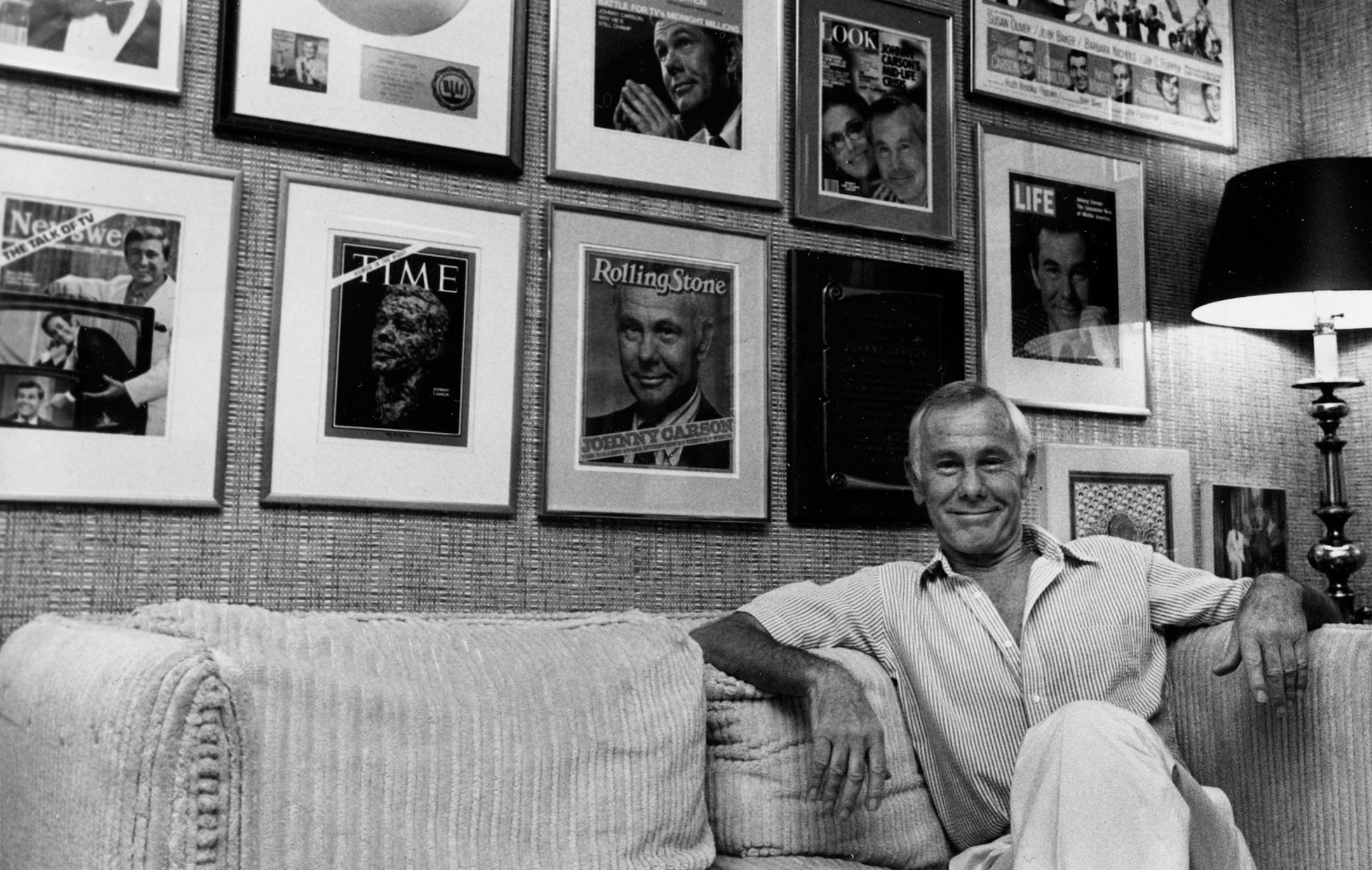Johnny Carson, host of the "Tonight Show," sits in his front office under a wall covered with framed magazine covers bearing his picture in Los Angeles, Ca., Sept. 29, 1983. Carson will celebrate his 21st anniversary on the late-night talk show. (AP Photo/Doug Pizac) ORG XMIT: APHS147