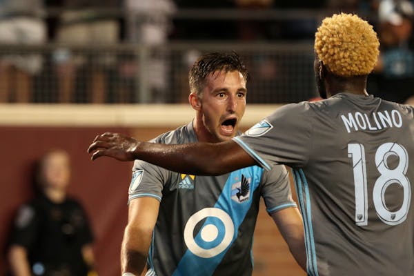 Minnesota United midfielder Ethan Finlay is congratulated by teammate Kevin Molino (18) after scoring in the first half against the Philadelphia Union