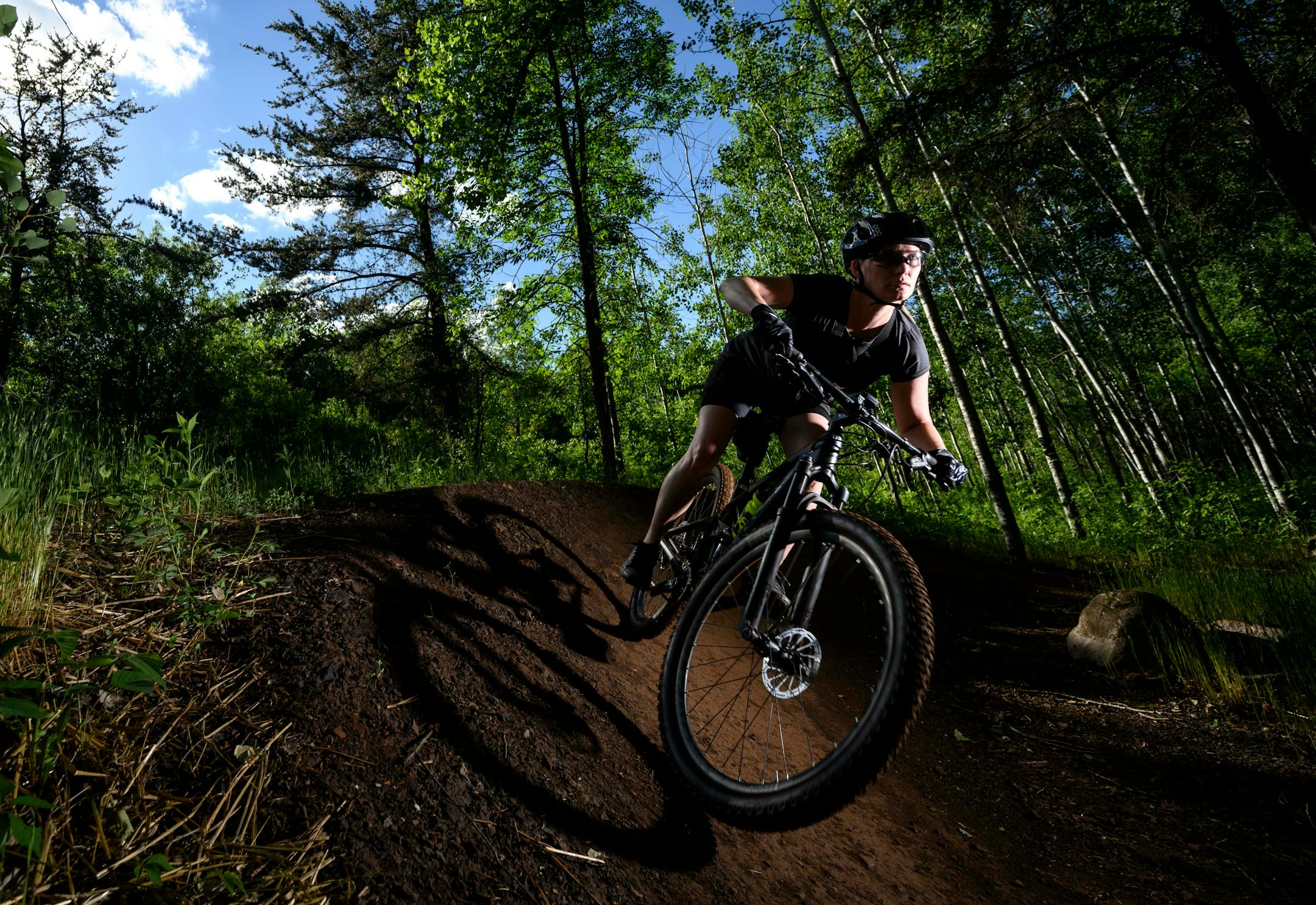 Kate Swanson, a helicopter flight nurse from Brainerd and avid mountain biker, cut around a berm on the "Drawpoint Trail" Tuesday at Cuyuna Country State Recreation Area. "Something just calls to me," said Swanson of Cuyuna. "it's just good people."