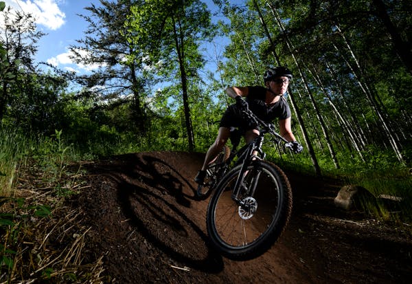 Kate Swanson, a helicopter flight nurse from Brainerd and avid mountain biker, cut around a berm on the "Drawpoint Trail" Tuesday at Cuyuna Country St
