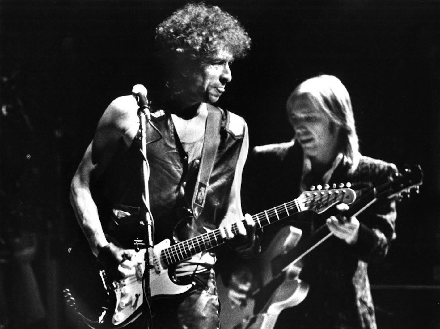 Bob Dylan performing at the Metrodome, June 26, 1986. Dylan's backing band was Tom Petty and the Heartbreakers. Tom Petty plays behind Dylan in this photo. Star Tribune photo by staff photographer Donna Terek.