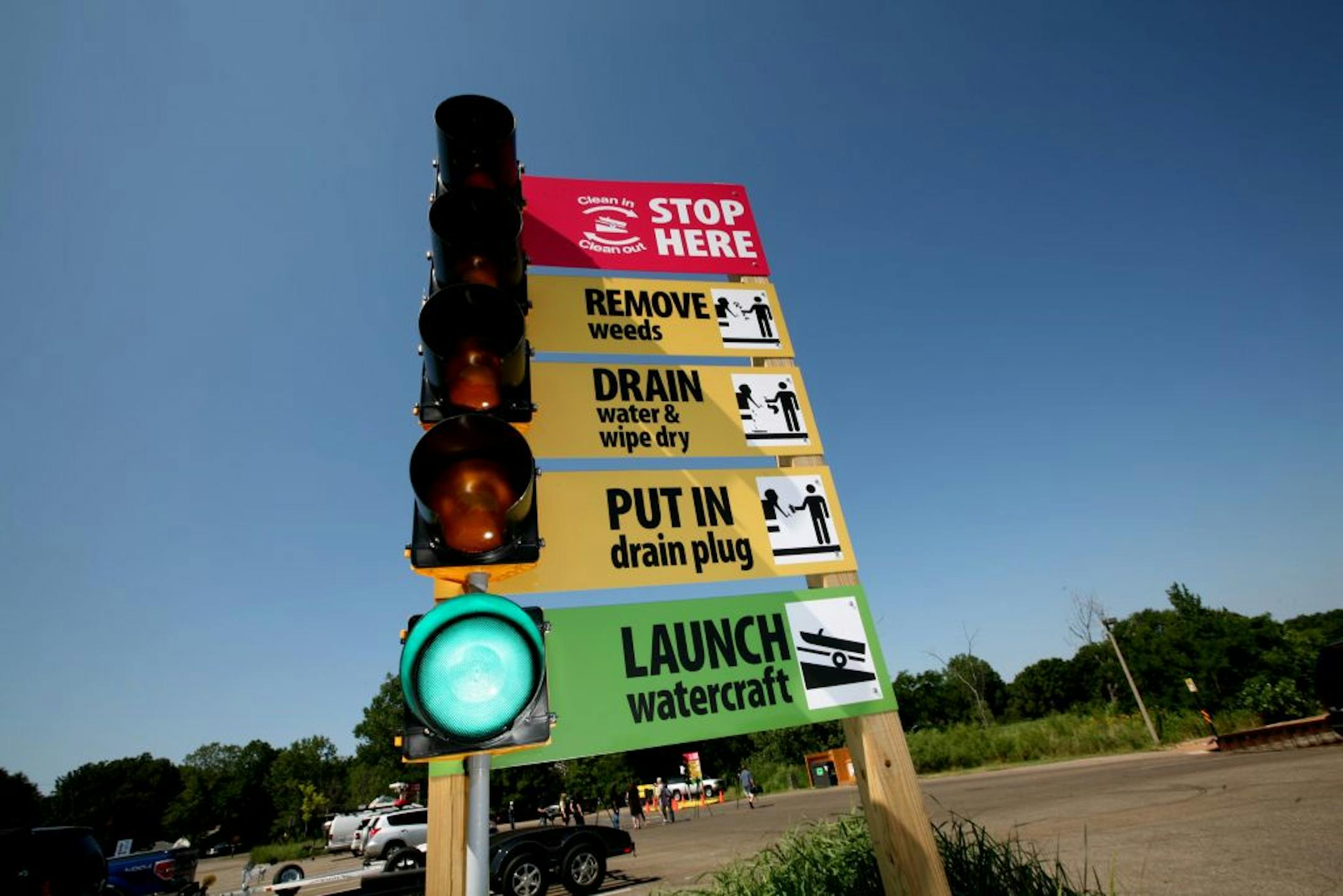 Large signs with blinking lights are part of a new pilot program to prevent the transport of invasive species at the North Arm Public Boat Access in Orono July 11, 2012. Rather than focus on education, the first priority of the project is to grab attention, prompting action.