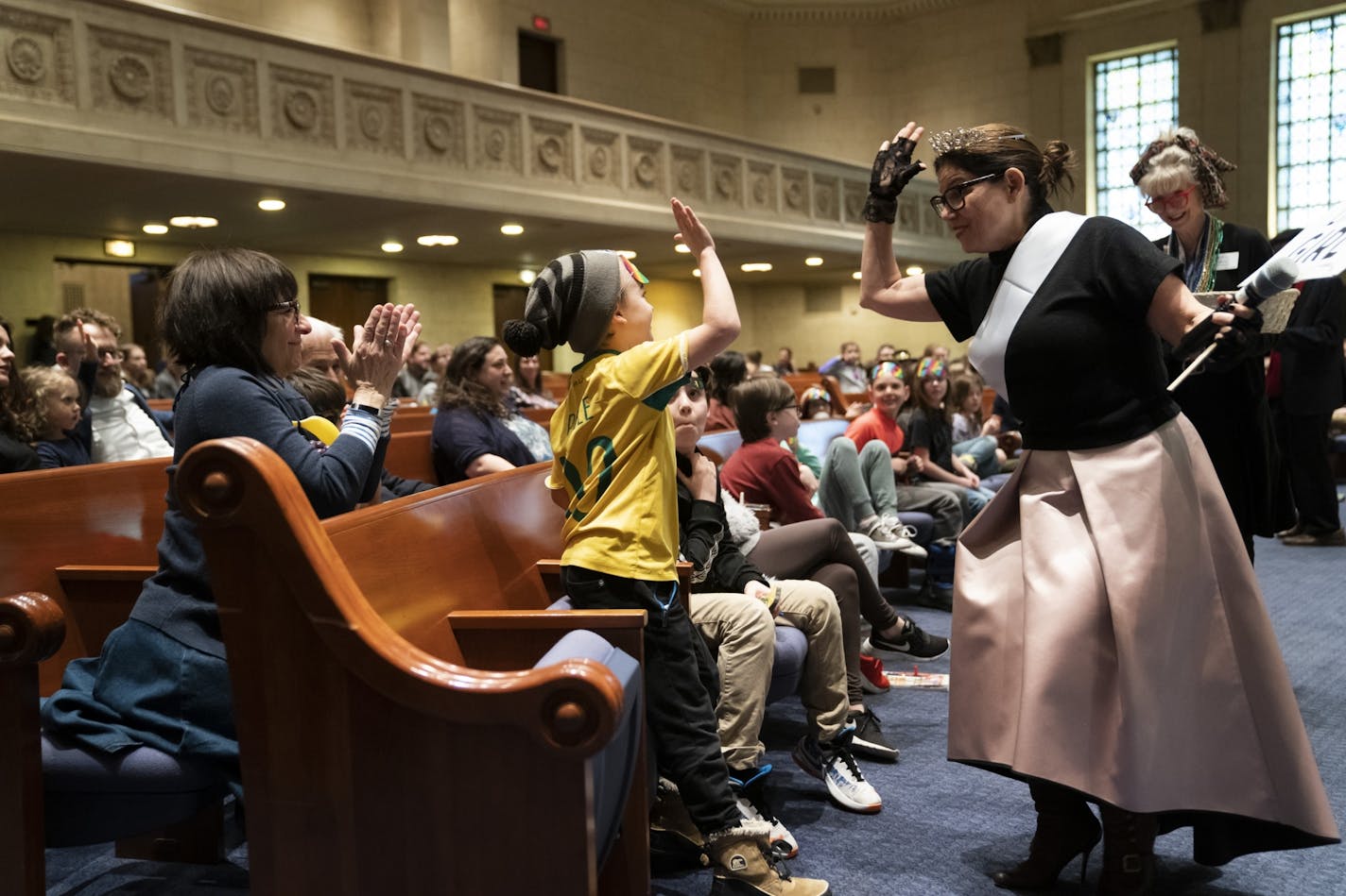 Rabbi Marcia Zimmerman said security is only part of how Jews should respond to attacks like the one in Monsey. "The other way is Jewish pride, feeling strongly connected to the Jewish community, not hiding one's Judaism." Zimmerman gave Charlie Paton a high five after her answered a trivia question right during a service celebrating the festival of Purim at Temple Israel in Minneapolis on March 20, 2019.