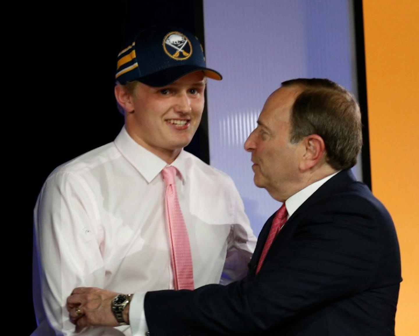 Casey Mittelstadt, left, shakes hands with NHL Commissioner Gary Bettman after being selected by the Buffalo Sabres in the first round of the NHL hockey draft, Friday, June 23, 2017, in Chicago.