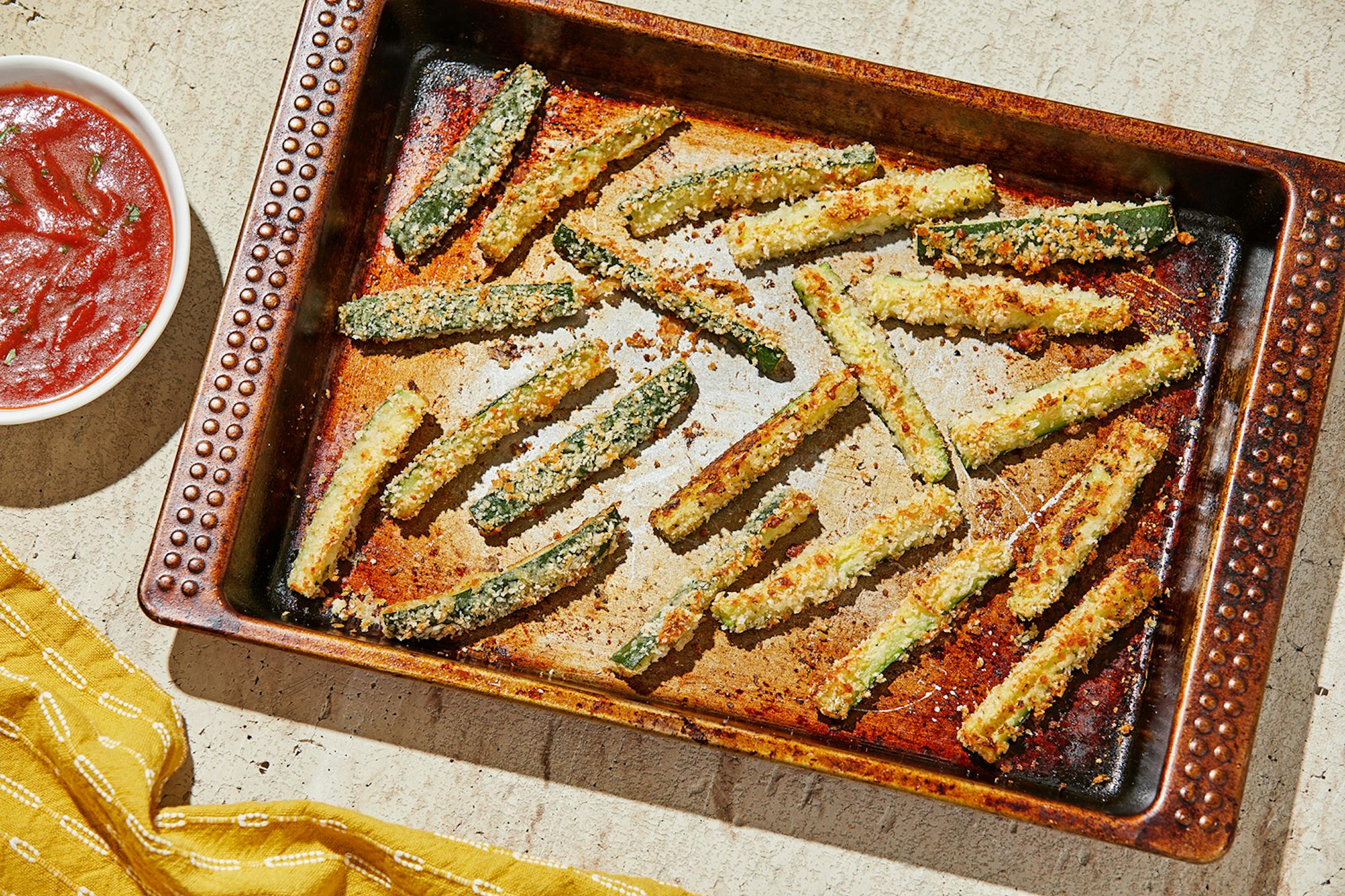 Baked zucchini "fries" with parmesan are a no-fry, irresistible side. MUST CREDIT: Photo for The Washington Post by Tom McCorkle