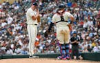 Minnesota Twins pitcher Louie Varland, left, takes a moment with catcher Christian Vazquez after giving up two home runs in a row against the Detroit 