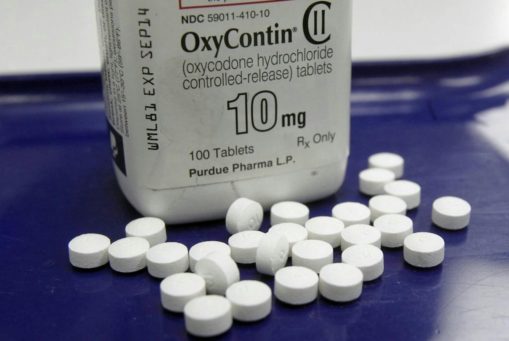 FILE - This Feb. 19, 2013, file photo, shows OxyContin pills arranged for a photo at a pharmacy in Montpelier, Vt. Prescription painkillers should not be a first-choice for treating common ailments like back pain and arthritis, according to new federal guidelines designed to reshape how doctors prescribe drugs like OxyContin and Vicodin. Amid an epidemic of addiction and abuse tied to these powerful opioids drugs, the CDC is urging general doctors to try physical therapy, exercise and over-the-c