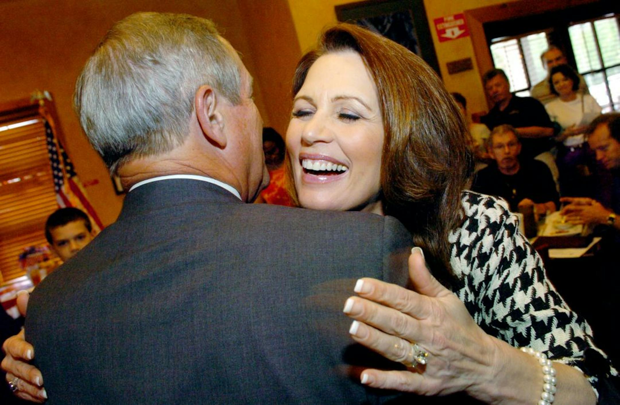 Potential presidential candidate U.S. Rep. Michele Bachmann, R-Minn., hugs U.S. Rep. Joe Wilson, R-S.C., as she makes her entrance during an appearance at Montana's Restaurant & Grizzly Bar, Saturday, April 16, 2011, in Bluffton, S.C. Both Bachmann and Wilson, along with state Sen. Tom Davis, R-Beaufort, spoke at the event.
