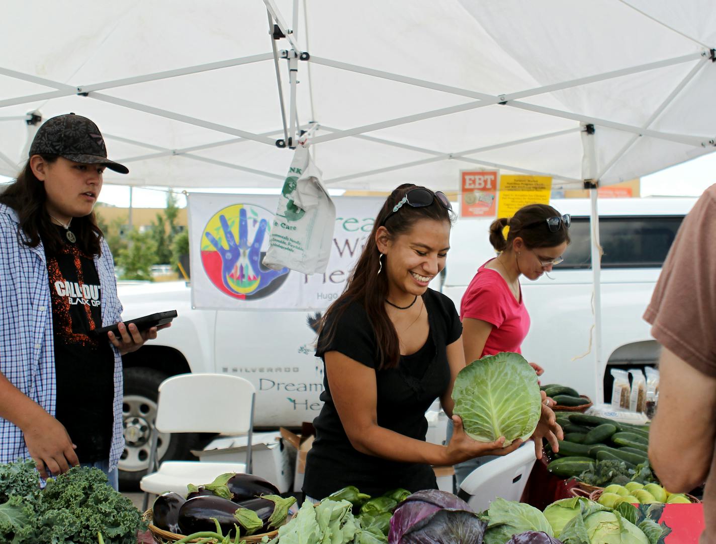 Jesse Quaderer, left, and intern Sigwan Rendon worked at Dream of Wild Health farm&#x2019;s booth at the Midtown Farmer&#x2019;s Market.