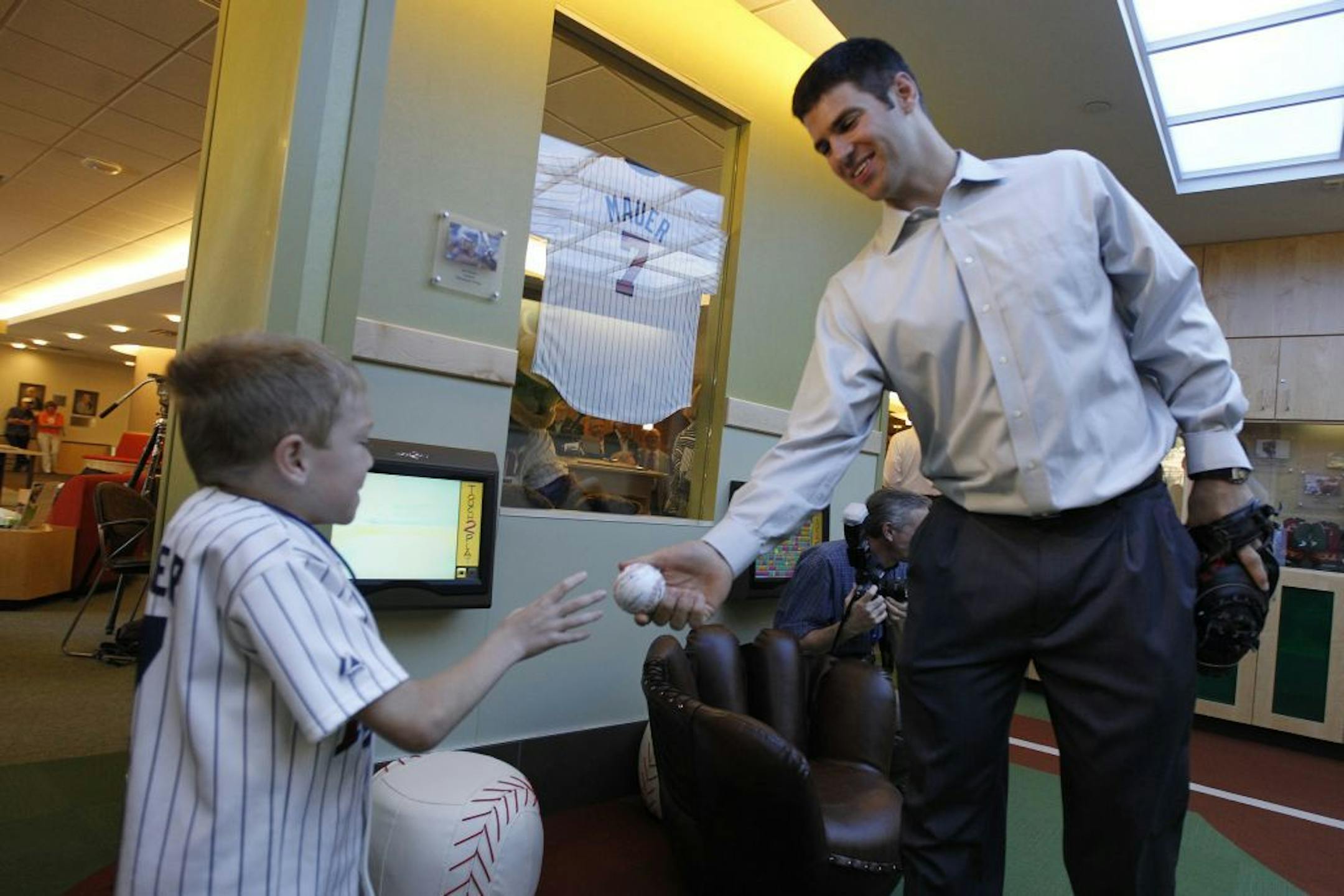 Joe Mauer passed a ball to Gillette patient Logan Swedberg Monday morning at a playroom he donated to Gillette Children's Hospital in St. Paul. The sports-themed room is 22' long x 14' wide and comes complete with signed memorabilia from professional Minnesota teams, including the Twins and Vikings.